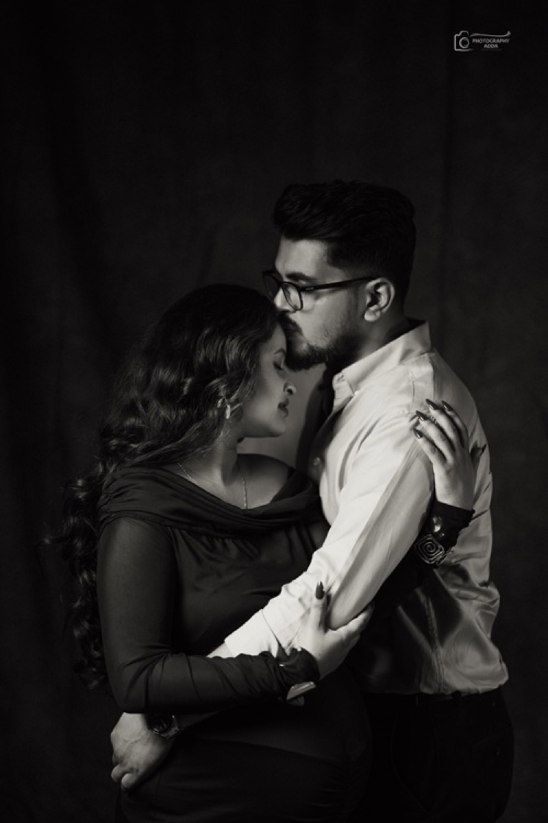 Elegant black maternity couple studio portrait