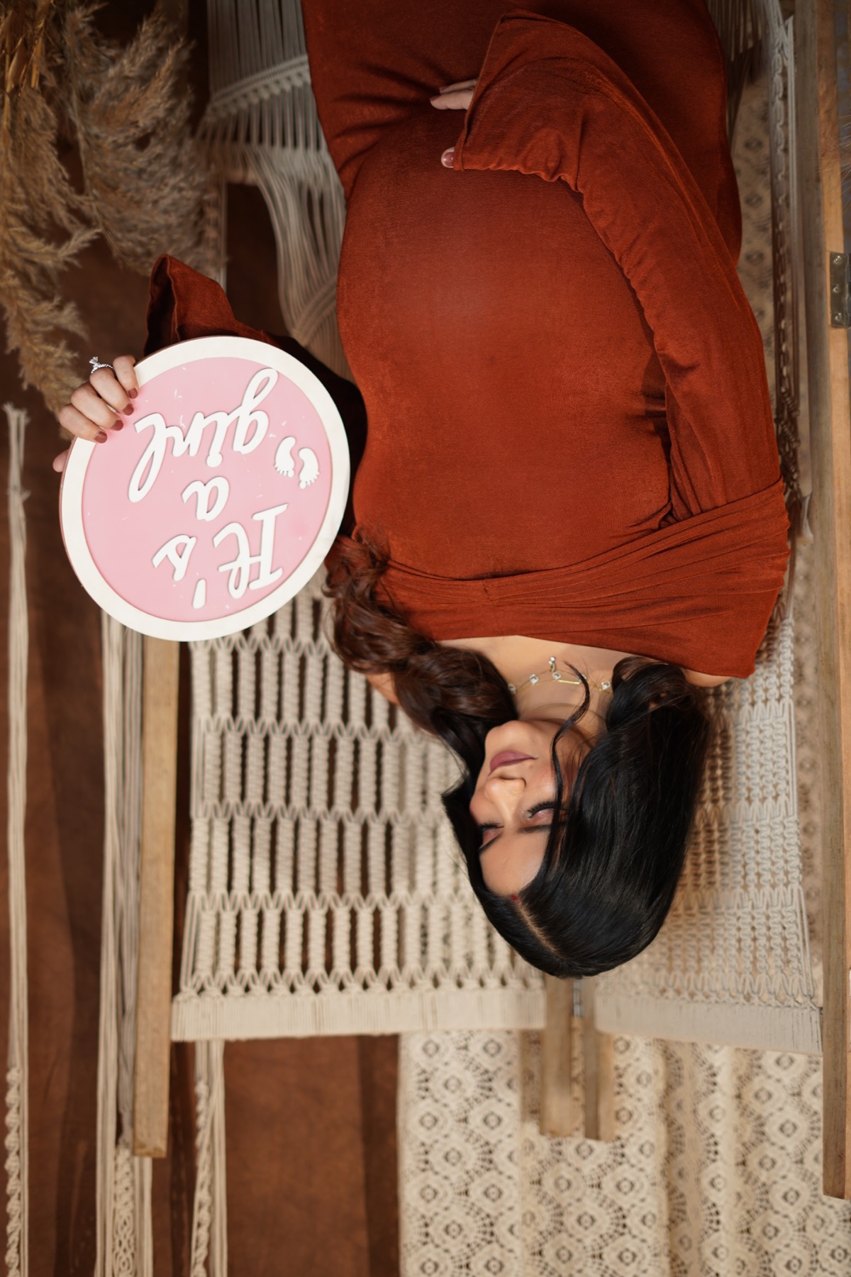 Maternity brown gown with it is a girl prop