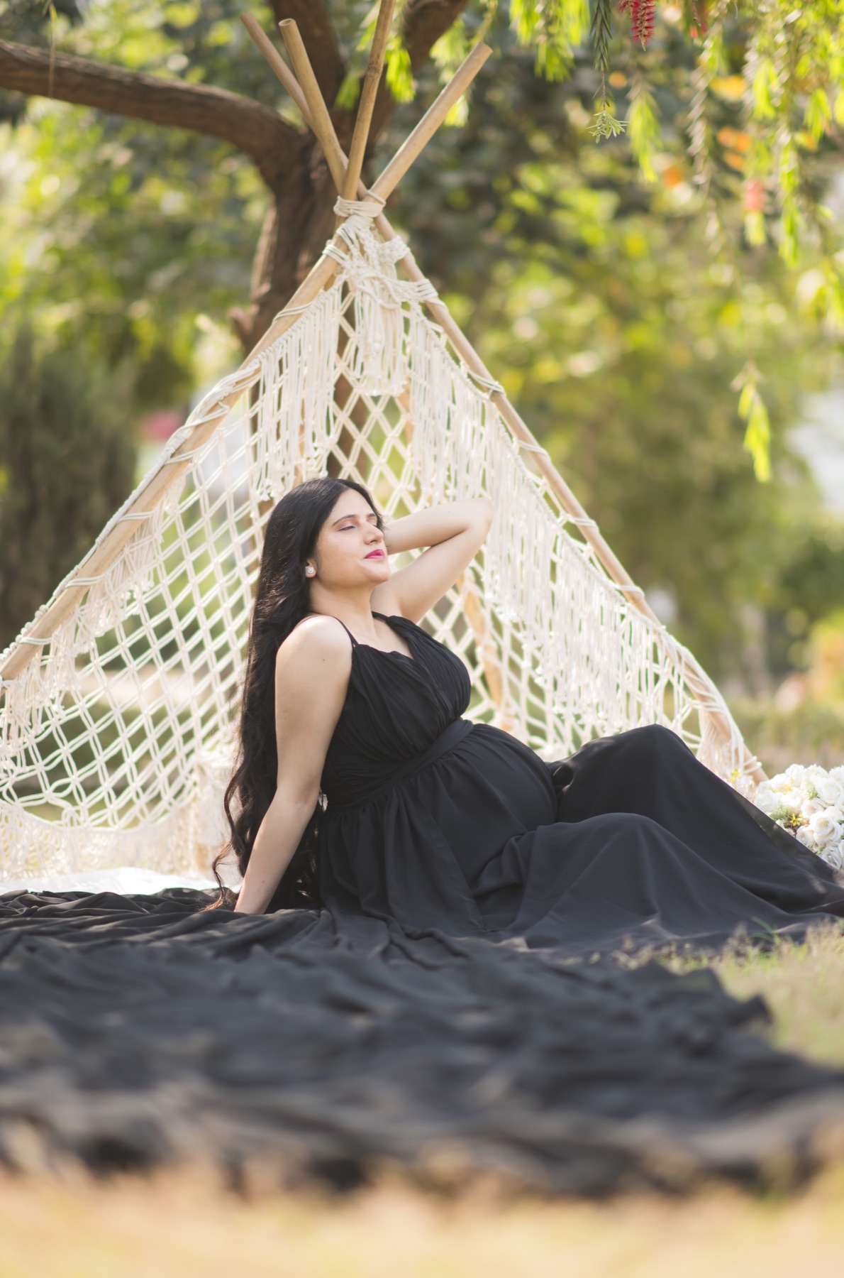 Outdoor black gown maternity photoshoot with teepee prop