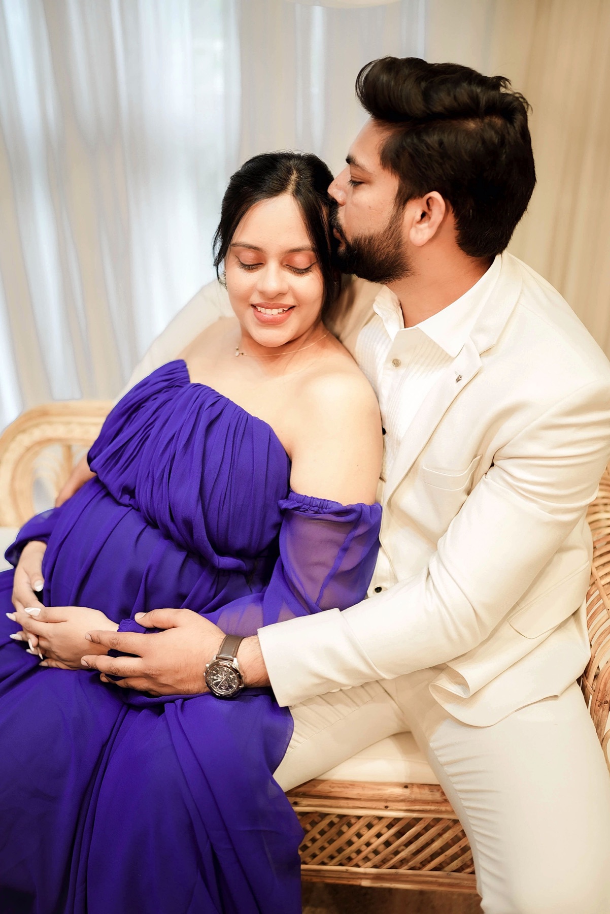Purple gown maternity couple studio portrait