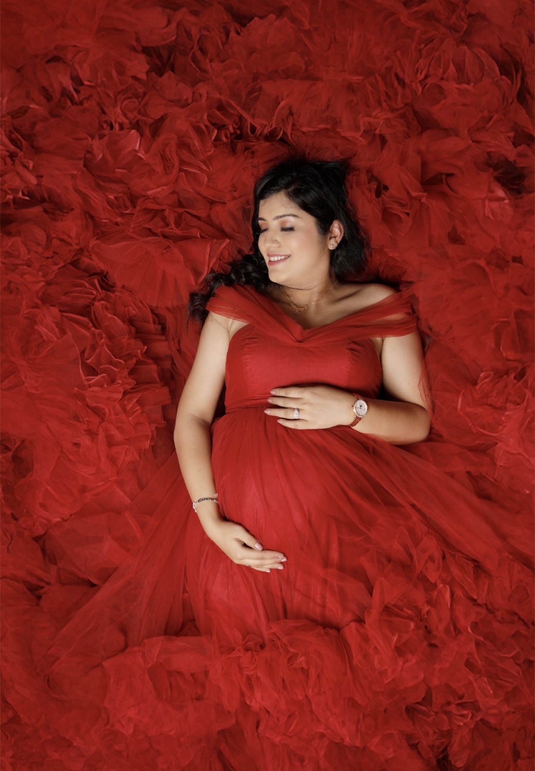 Silver maternity red gown lying portrait with professional retouching