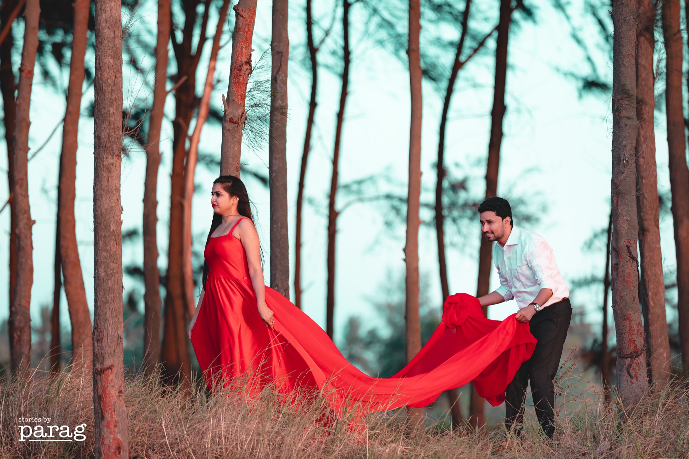 Red rental gown for prewedding forest couple shoot