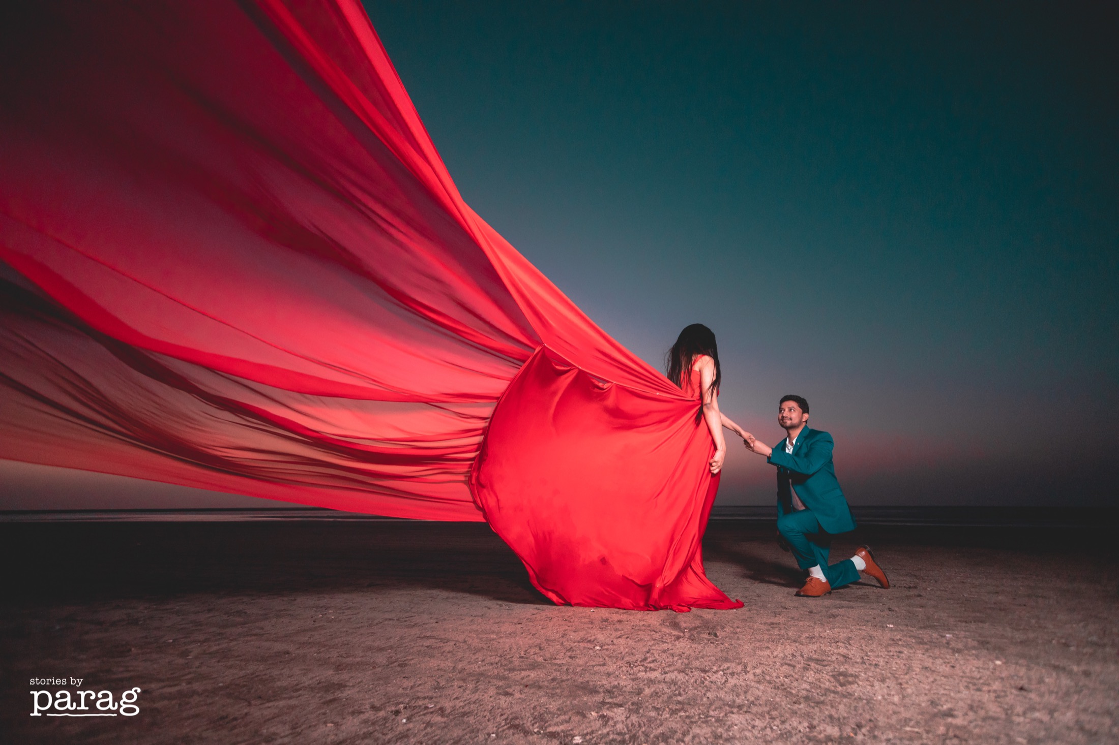 Prewedding red trail gown beach photoshoot